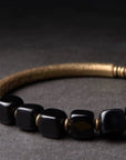 Zwarte obsidiaan blokken armband met bronzen armband